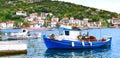 Traditional Greek fishing harbour with boats white houses Royalty Free Stock Photo