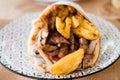 Traditional Greek food gyros pita with fries, vegetables and tzatziki sauce Royalty Free Stock Photo