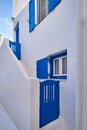 Traditional Greek house on Cyclades or Aegean islands. Whitewashed walls and dark blue doors, shutters and window frames Royalty Free Stock Photo