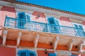 Traditional greek house facade with blue windows, shutters and balconies, Greece Royalty Free Stock Photo