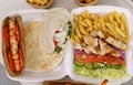 Traditional Greek kalamaki dish served in a take away container. Pita souvlaki, grilled chicken meat and sliced vegetables in a Royalty Free Stock Photo