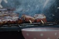 Traditional greek pork souvlaki being grilled on the barbecue