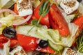 Traditional greek salad with fresh vegetables, feta cheese and olives. Top view. Selective focus Royalty Free Stock Photo