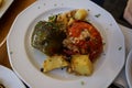 Traditional greek summer dish, baked stuffed vegetables, tomatoes, peppers and roasted potatoes with chopped mint Royalty Free Stock Photo