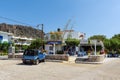 Traditional greek tavern with parked blue car.