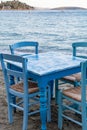 Traditional greek tavern with wooden tables on sandy beach near water waiting for tourists in Tolo, Peloponnese, Greece Royalty Free Stock Photo