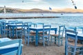 Traditional greek tavern with wooden tables on sandy beach near water waiting for tourists in Tolo, Peloponnese, Greece Royalty Free Stock Photo