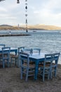 Traditional greek tavern with wooden tables on sandy beach near water waiting for tourists in Tolo, Peloponnese, Greece Royalty Free Stock Photo