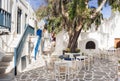 Traditional greek village Naoussa on Paros island, Greece. Beautiful street with cafe tables Royalty Free Stock Photo