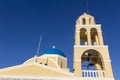 Traditional Greek white church arch with cross and bells in village Oia of Cyclades Island Santorini Greece Royalty Free Stock Photo