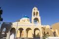 Traditional Greek white church arch with cross and bells in village Oia of Cyclades Island Santorini Greece Royalty Free Stock Photo