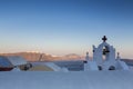 Traditional Greek white church arch with cross and bells in village Oia of Cyclades Island Santorini Greece Royalty Free Stock Photo