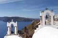 Traditional Greek white church arch with cross and bells in village Oia of Cyclades Island Santorini Greece Royalty Free Stock Photo