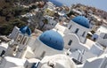 Traditional Greek white church arch with cross and bells in village Oia of Cyclades Island Santorini Greece Royalty Free Stock Photo