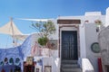 Traditional greek white house with dark wooden door, famouse Santorini view, traveling concept