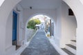 Traditional greek whitewashed buildings, cobblestone streets and stone structure arch. Ioulida village,Tzia, Kea island, Greece