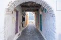 Traditional greek whitewashed buildings, cobblestone streets and stone structure arch. Ioulida village,Tzia, Kea island, Greece