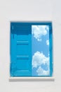 Traditional greek window against a white wall and the cloudy sky Royalty Free Stock Photo