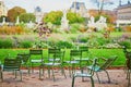 Traditional green chairs in the Tuileries garden in Paris on a warm and sunny fall day