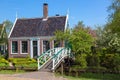 Traditional green dutch house with little wooden bridge against blue sky in the Zaanse Schans village, Netherlands. Famous tourism Royalty Free Stock Photo