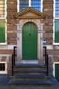 Traditional green front door with steps in Amsterdam