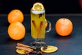 Traditional grog drink with cinnamon sticks and orange