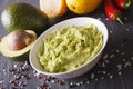 Traditional guacamole sauce with ingredients close-up. Horizontal Royalty Free Stock Photo