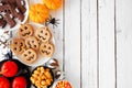 Traditional Halloween treat side border over a white wood background Royalty Free Stock Photo