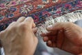 Traditional hand sewing fixing old vintage antique persian carpet up close