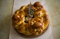 Traditional handmade braided bread with Easter eggs on the kitchen table