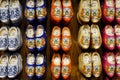 Traditional handmade colored Dutch wooden clogs in wooden shoe workshop
