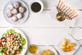 Traditional Hanukkah dishes on the white wooden table