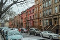 Traditional Harlem Neighborhood in New York City. Beautiful Colored Houses. Road with Parked Cars. Urban Street Photography