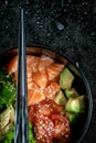 Traditional Hawaiian Poke bowl salad with vegetables and raw fish salmon, chopsticks Royalty Free Stock Photo