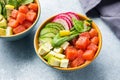 Traditional Hawaiian Poke salad with salmon, avocado rice and vegetables in a bowl on two persons Royalty Free Stock Photo