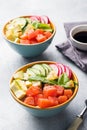 Traditional Hawaiian Poke salad with salmon, avocado rice and vegetables in a bowl on two persons Royalty Free Stock Photo