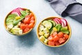 Traditional Hawaiian Poke salad with salmon, avocado rice and vegetables in a bowl on two persons Royalty Free Stock Photo