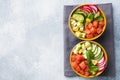 Traditional Hawaiian Poke salad with salmon, avocado rice and vegetables in a bowl on two persons. Top view Copy space Royalty Free Stock Photo