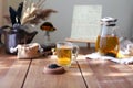 Traditional heral tea with glass teapot, cup, dried rose buds. Flowers on wooden table at home,sunlight background