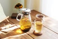 Traditional heral tea with glass teapot, cup, dried rose buds. Flowers on wooden table at home,sunlight background