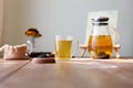 Traditional heral tea with glass teapot, cup, dried rose buds. Flowers on wooden table at home,sunlight background