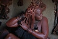 A traditional himba tribe woman doing her beauty procedure Royalty Free Stock Photo