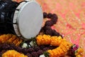 Traditional hindu prayer beads rudraksha and musical instrument of God Shiva Damaru drum on a red saree background
