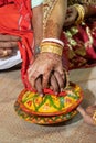 Traditional Hindu wedding rituals decoration close-up shot. Bride and groom holding hands on a decorated clay pot. Hinduism Royalty Free Stock Photo