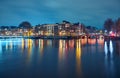 Traditional and historical buildings by the canal. Night cityscape in  Amsterdam Royalty Free Stock Photo