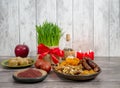 the traditional holiday of the vernal equinox Nawruz. Festive table in honor of Navruz. Wheat with a red ribbon