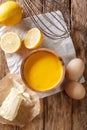 Traditional hollandaise sauce with ingredients eggs, lemon, butter close-up. vertical top view Royalty Free Stock Photo