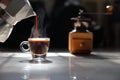 Traditional home brew espresso coffee pouring into a small cup with grinder on the dark background by the morning light with copy Royalty Free Stock Photo