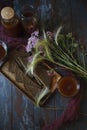 Traditional homemade beverage kvass in glasses and bottles with summer bouqute of rye and yarrow, flat lay Royalty Free Stock Photo