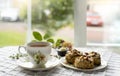Traditional Homemade British cheese scones with hot cup of tea, Baked scones english buns with bright light morning or Cozy scene